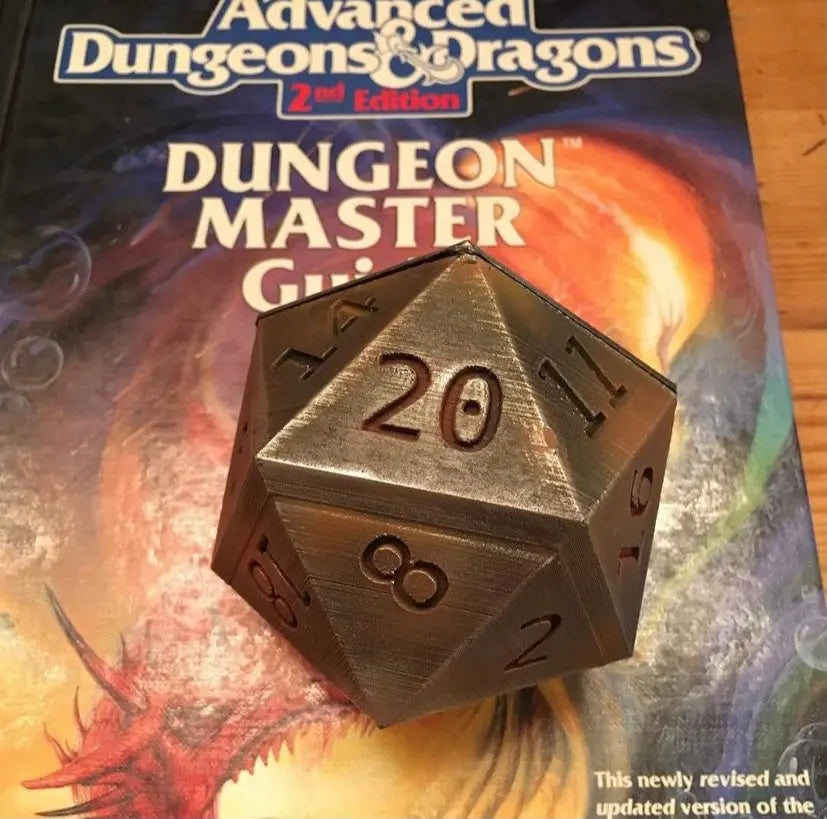20 sided die on a dungeon masters guide book