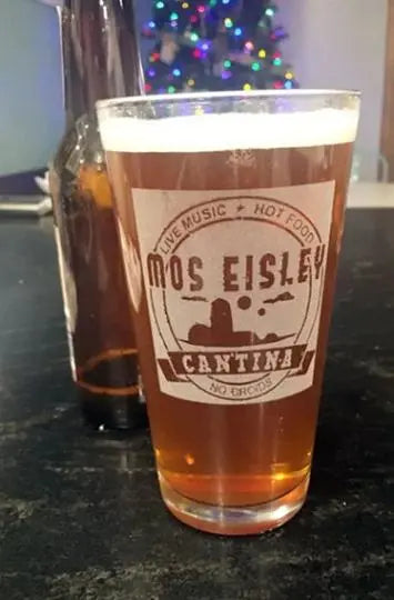 Mos Eisley Cantina Beer glass with Christmas tree behind